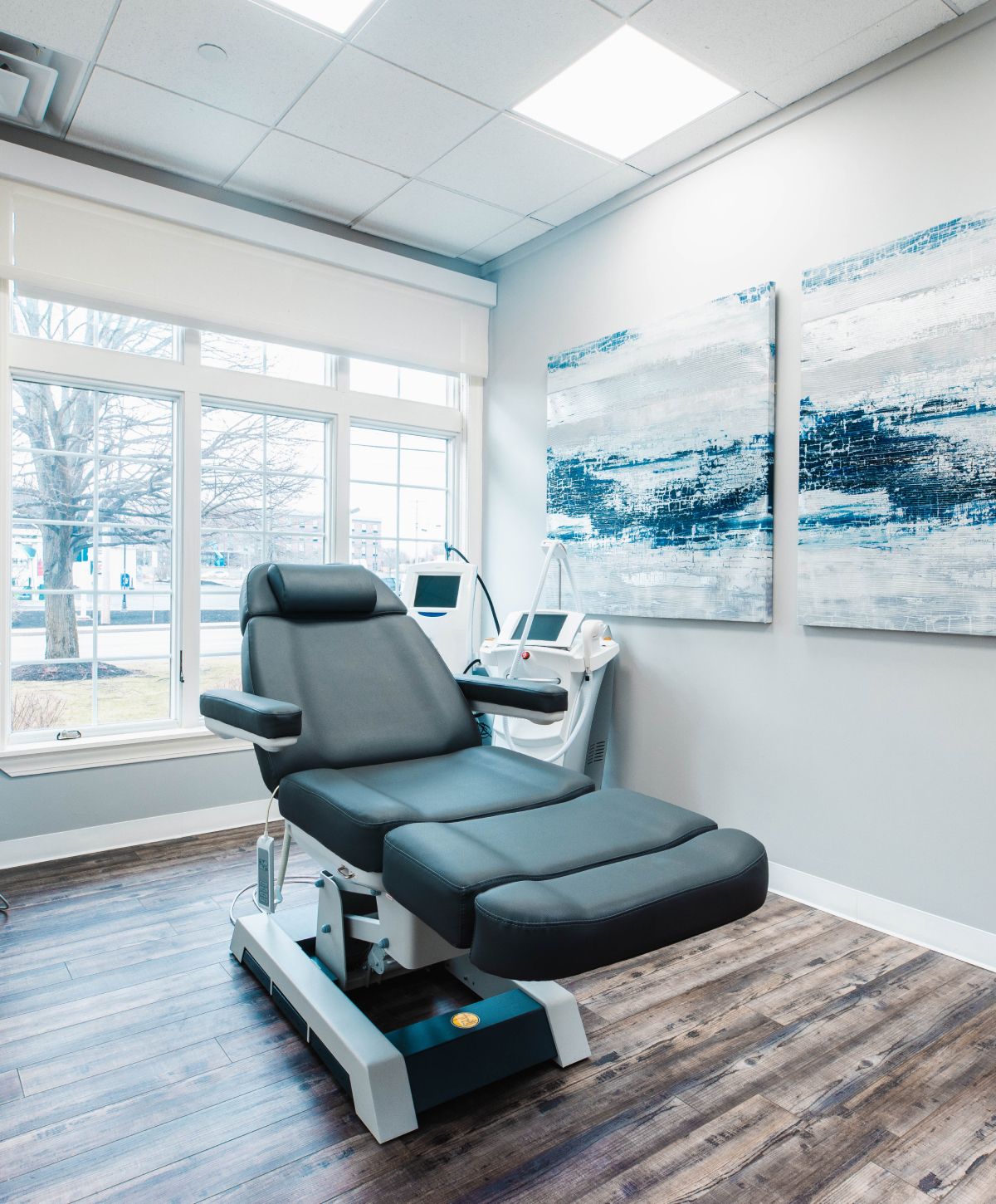 Treatment room with reclining chair and artwork.