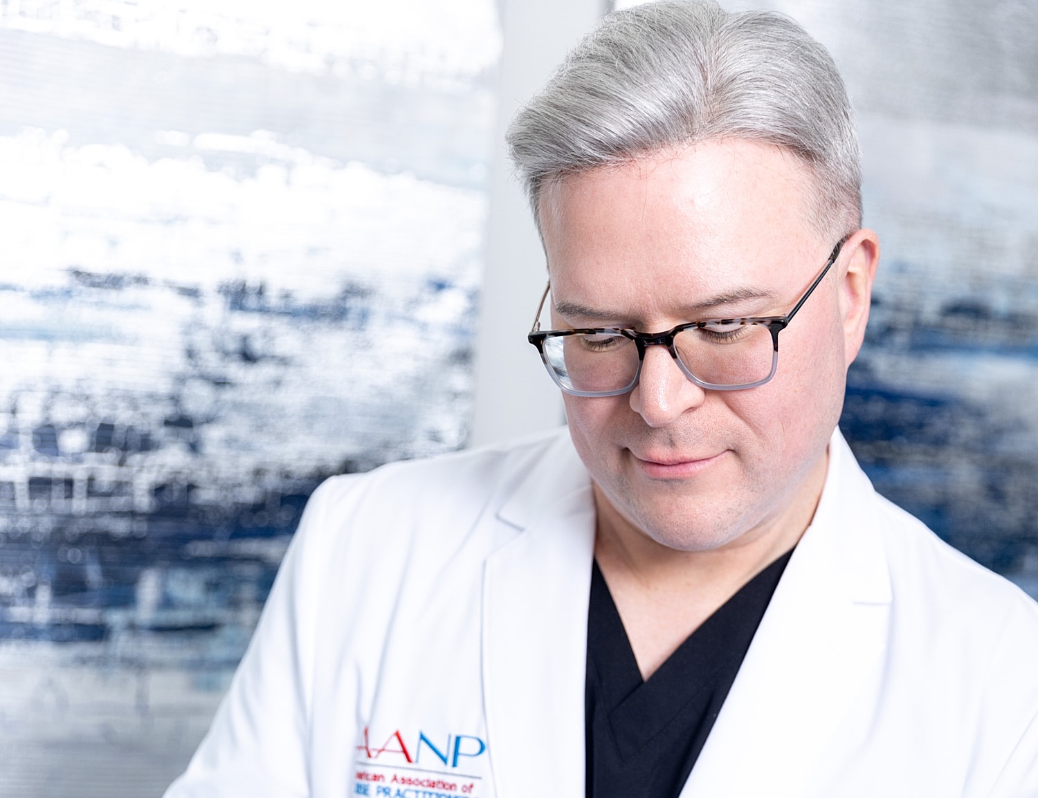 Medical professional in a white coat, focused.