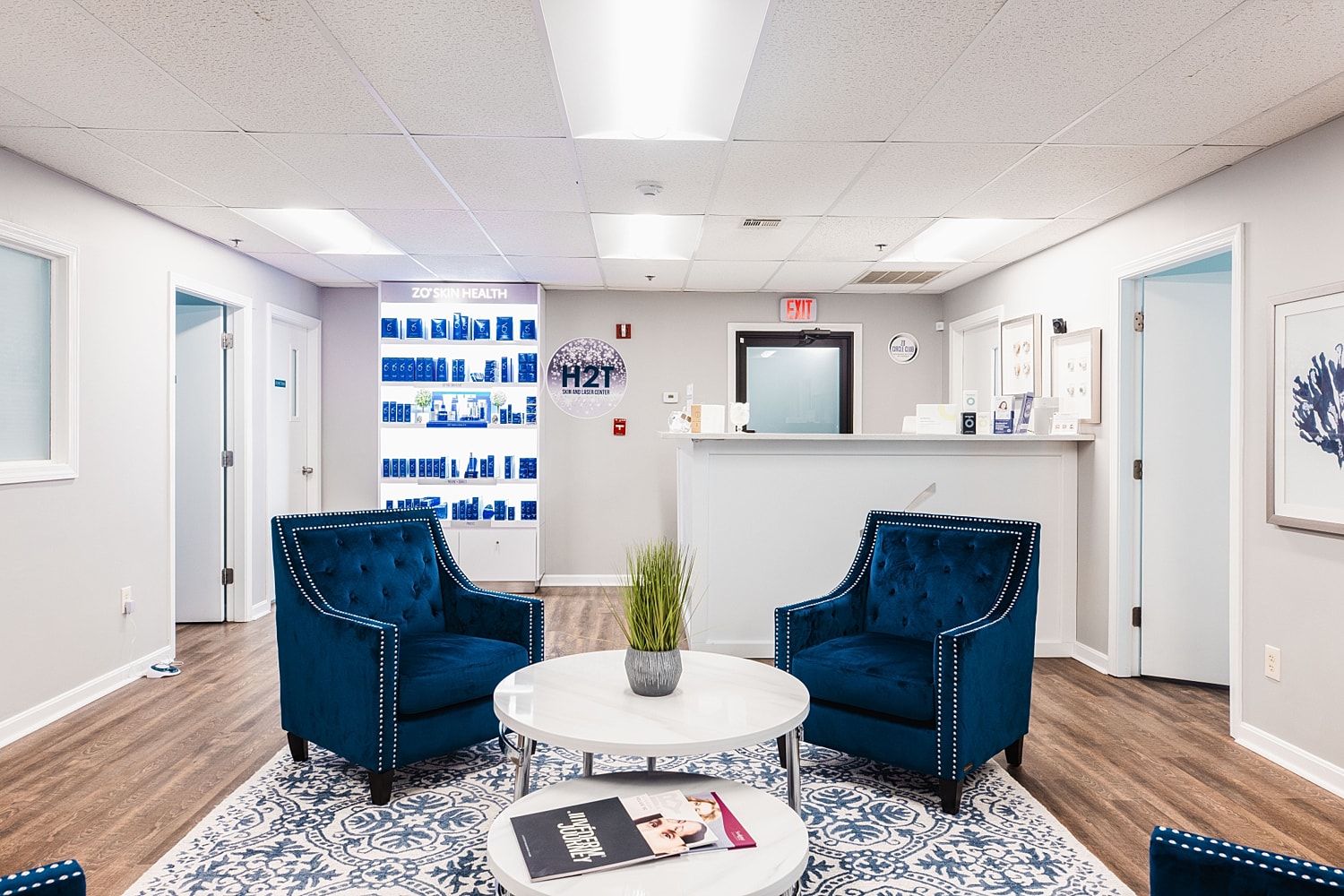 Modern waiting area with blue chairs and decor.