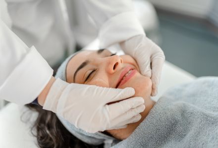 Woman receiving a facial treatment at spa.