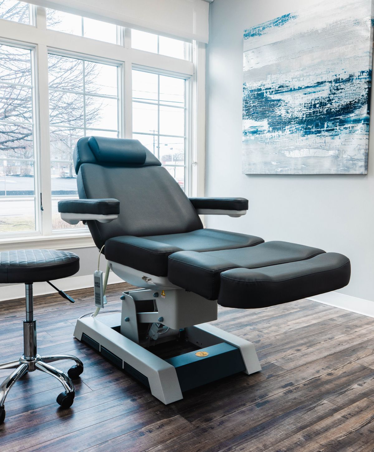 Medical examination chair in bright, modern room.