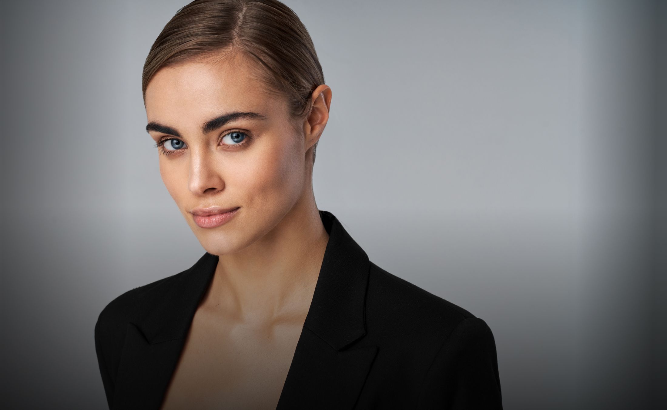 med spa model with brown har smiling