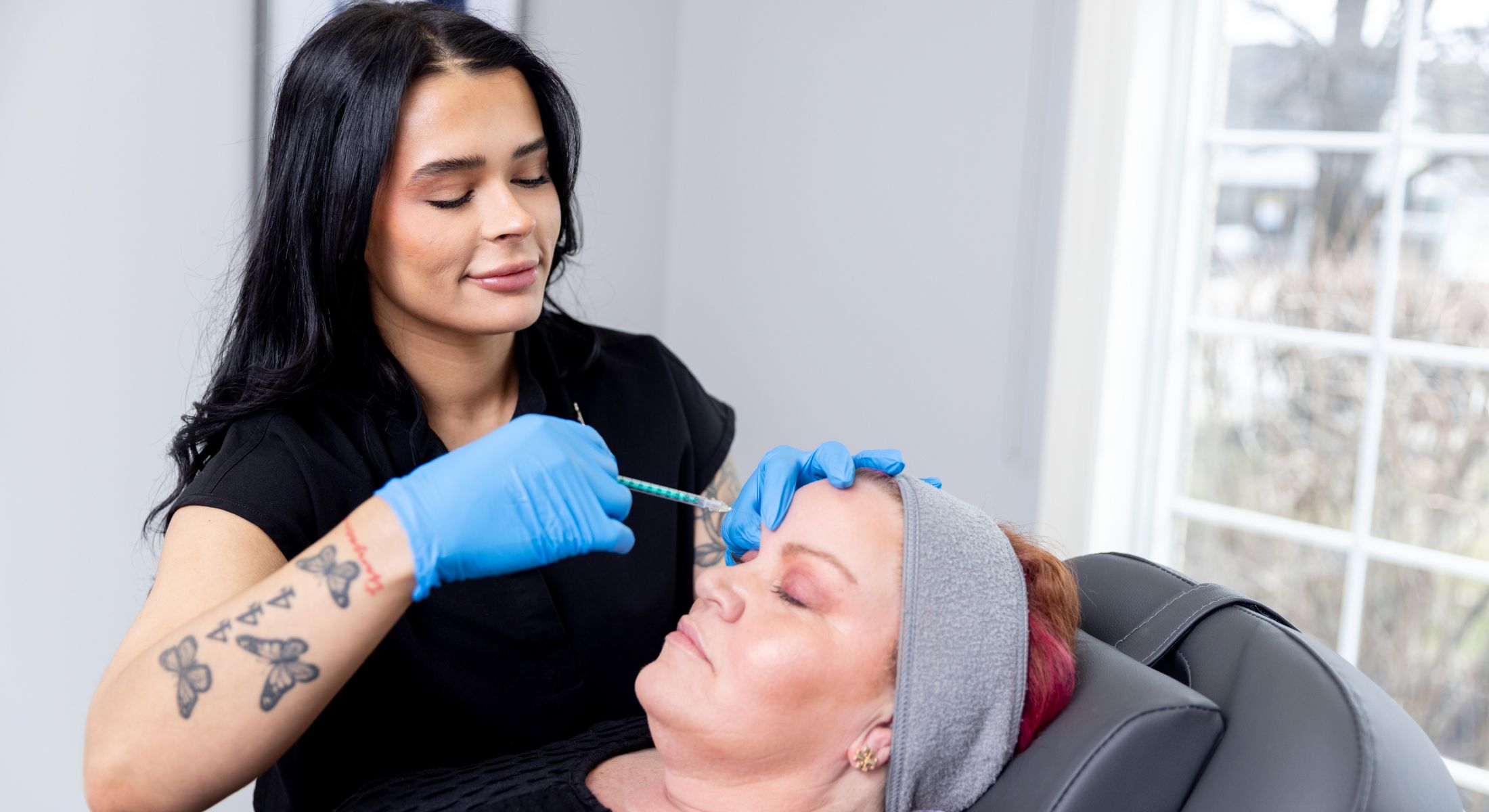 Cosmetic procedure in progress with client.